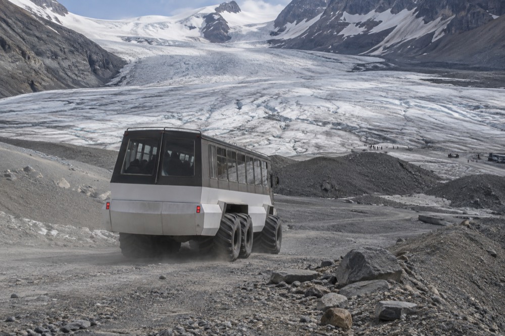 An Ice Explorer vehicle descending a steep slope toward the Athabasca Glacier