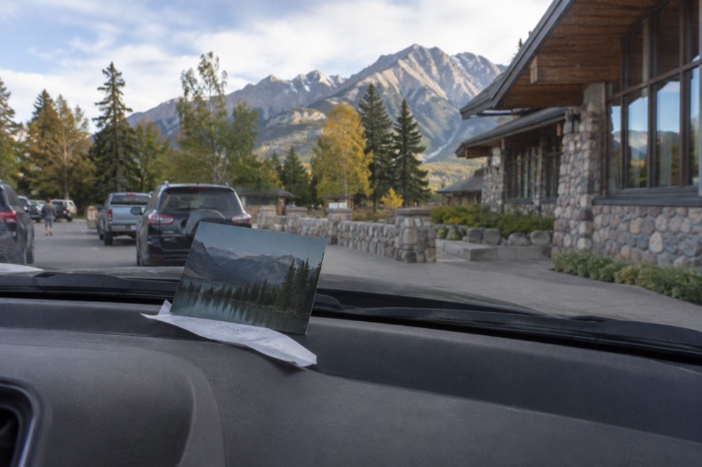 A dashboard of a parked car with a park pass displayed on it